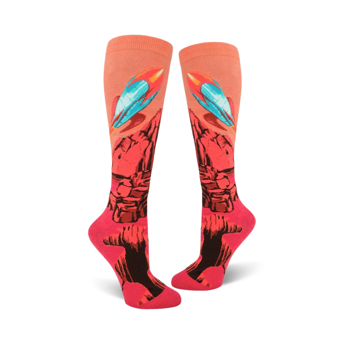 bright pink knee high women's socks feature a pattern of rockets blasting off from a red planet with blue flames.  }}