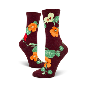 Lifestyle shot of a person wearing the burgundy nasturtium crew socks.