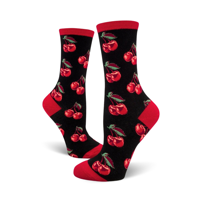Pair of women's crew socks. Black background with repeating red cherry pattern. Red accents at the cuffs. }}