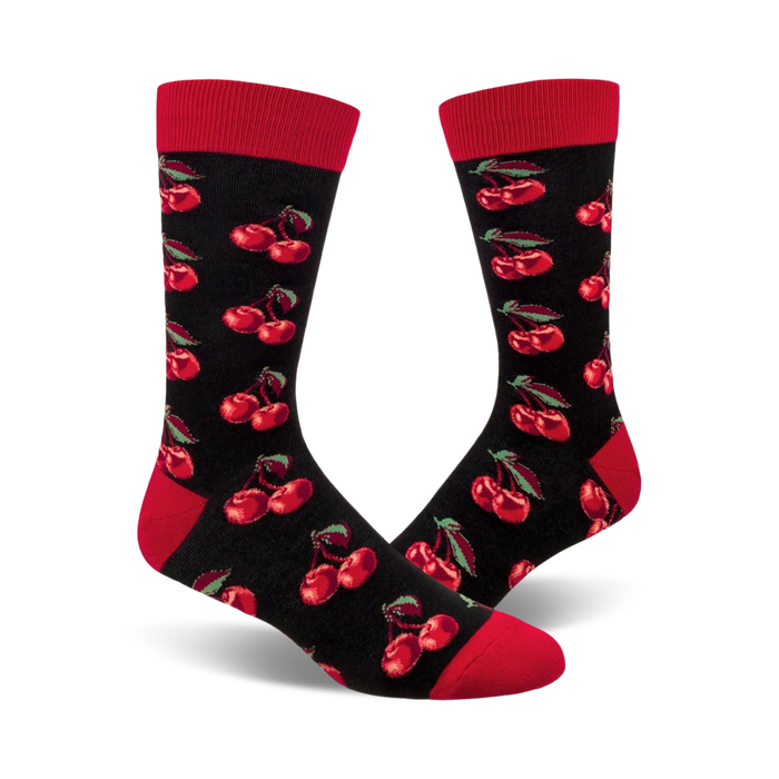 Pair of black crew socks with a repeating pattern of red cherries and green stems. Red cuffs. }}