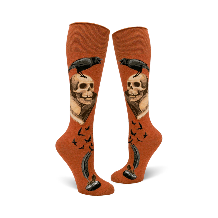 orange knee-high socks adorned with skulls, ravens, and feathersâ€”an eerie touch for halloween.   }}