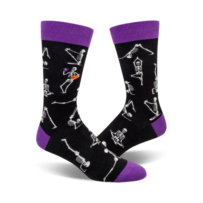 crew socks featuring halloween pattern of white skeleton yoga poses outlined in orange with purple toes, heels, and cuffs.    }}