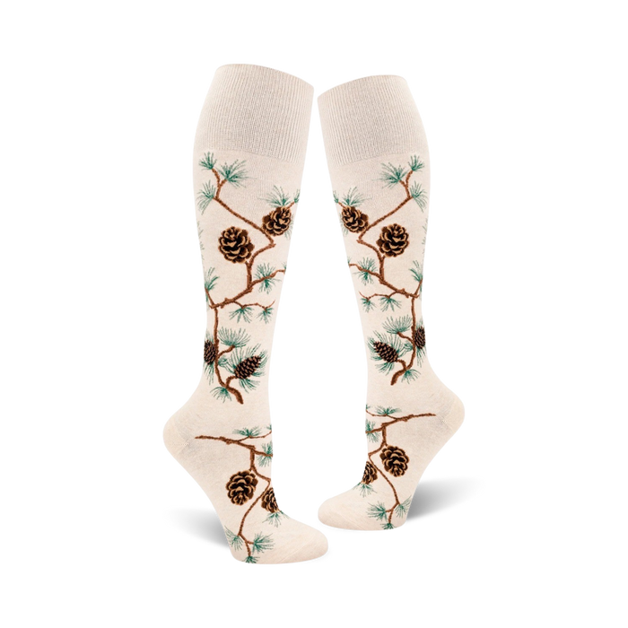 off-white knee high socks with pattern of brown pine cones and green pine needles on branch. perfect for women who love the outdoors.   }}