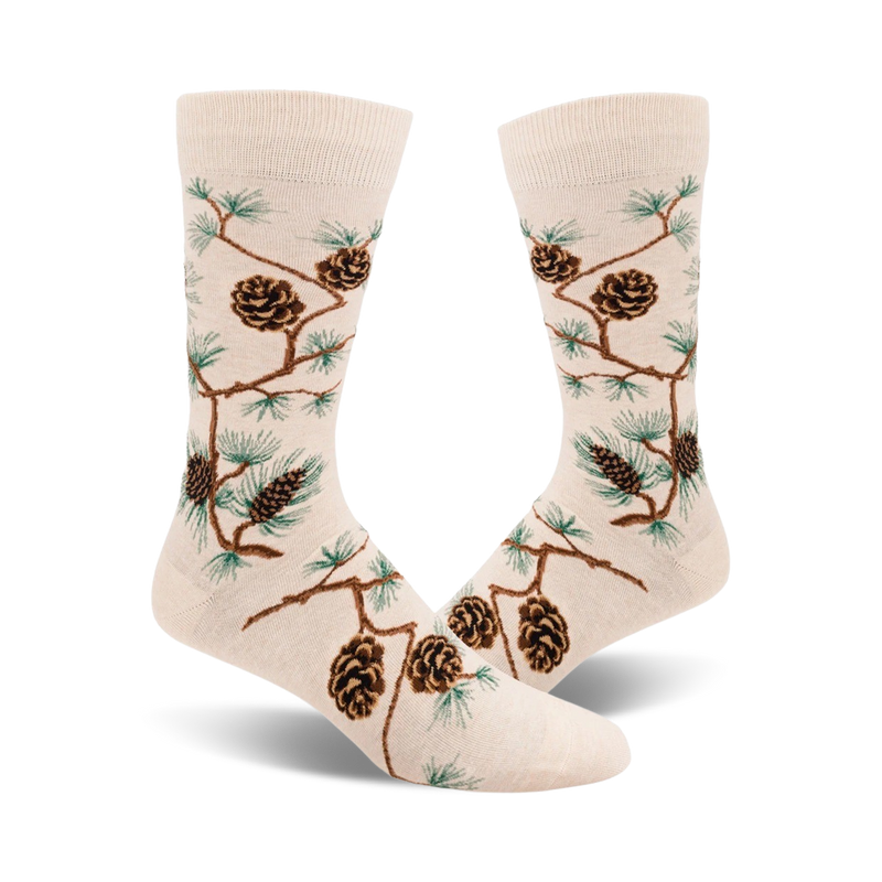 A pair of cream-colored crew socks adorned with a pattern of brown pinecones and green pine branches. The design is a whimsical, nature-inspired motif.