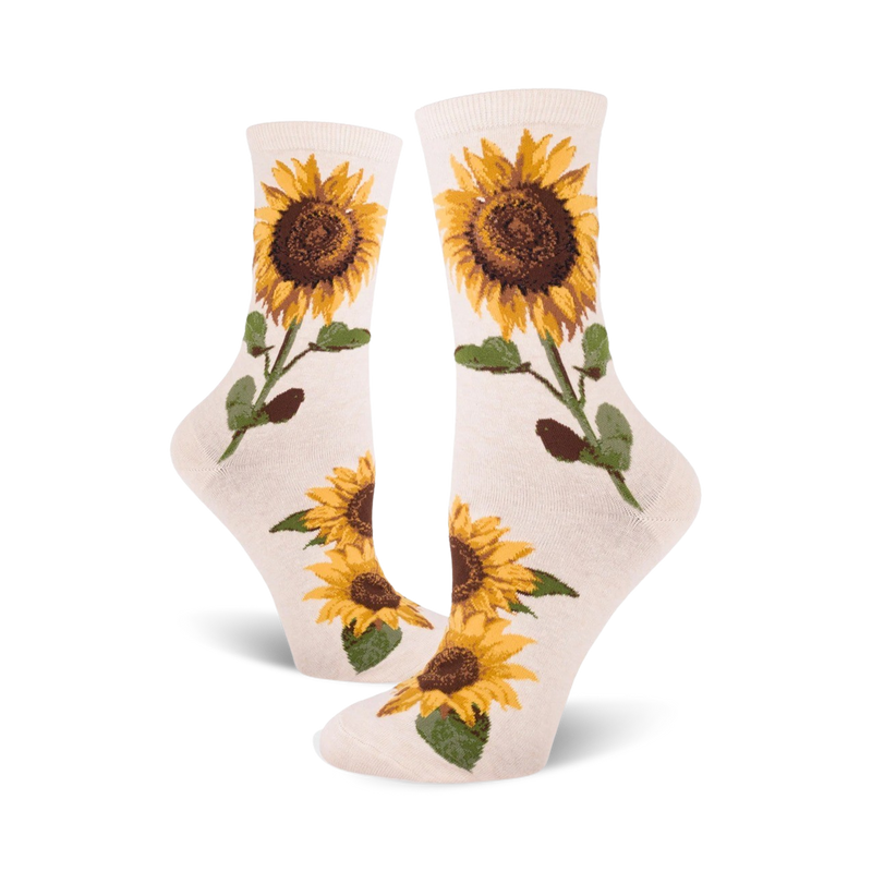 Cream crew socks with yellow and brown sunflower designs. Sunflowers are depicted with stems and leaves on a cream background.