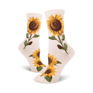 Cream crew socks with yellow and brown sunflower designs.  Sunflowers are depicted with stems and leaves on a cream background.