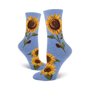 blue crew socks featuring a cheerful pattern of vibrant yellow sunflowers with brown centers and green leaves, designed for women.   