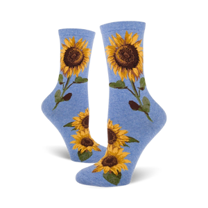 A pair of blue crew socks with sunflower designs shown on a white background.