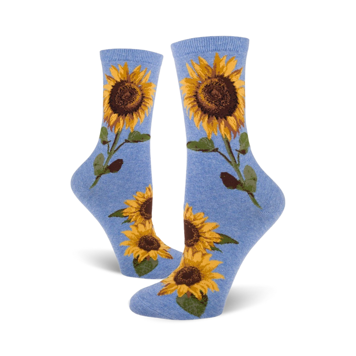 A pair of blue crew socks with sunflower designs shown on a white background.