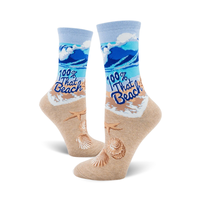  light blue crew socks with blue waves, starfish and seashells, and tan shore printed on fabric. caption 