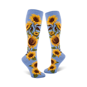 Lifestyle shot showing a person wearing the blue sunflower knee-high socks. They're styled with jeans and sneakers.
