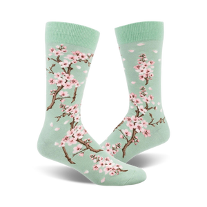 light green crew socks with a pattern of pink and white cherry blossoms. designed for men.  