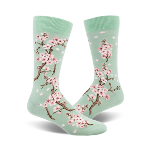 Pair of crew socks, mint green with pink cherry blossoms and petals.  Beautiful floral print.