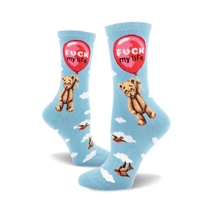 A pair of crew socks in light blue with a repeating pattern of a teddy bear holding a red 'F**k My Life' balloon and small birds in flight. }}