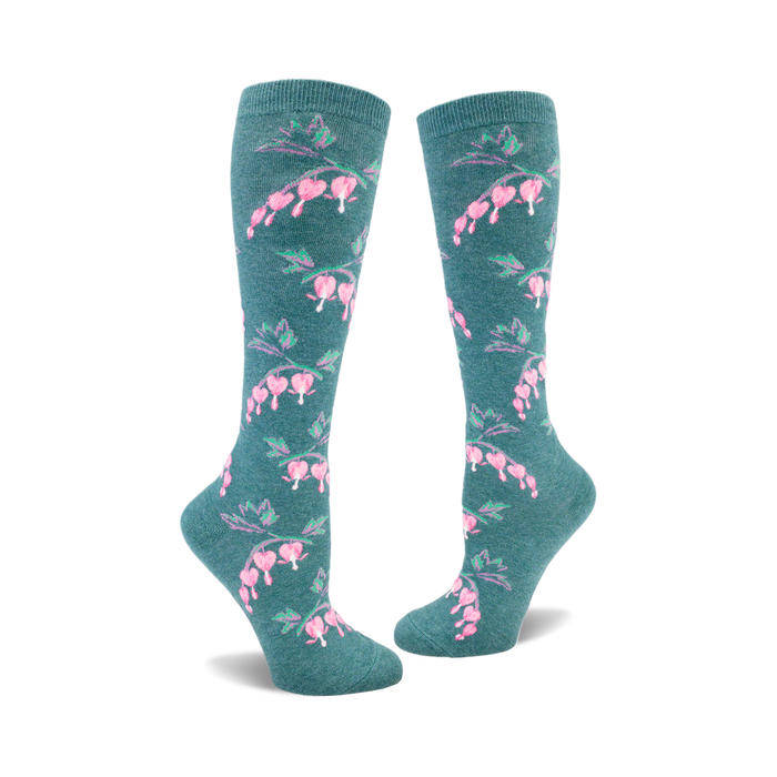Pair of teal knee-high socks adorned with a repeating pattern of pink bleeding heart flowers and green stems. }}