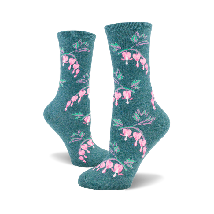 Pair of teal crew socks with a repeating pattern of pink bleeding heart flowers and green stems. }}