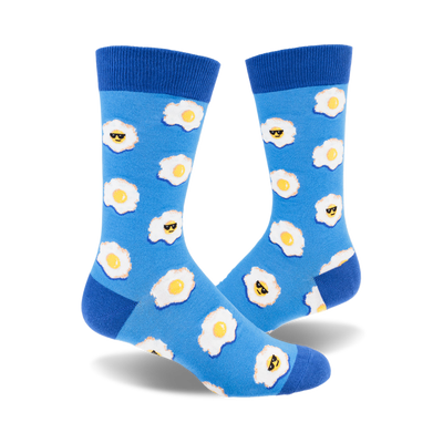 Pair of blue crew socks with a pattern of fried eggs wearing sunglasses.  The eggs are yellow and white on a light blue background.