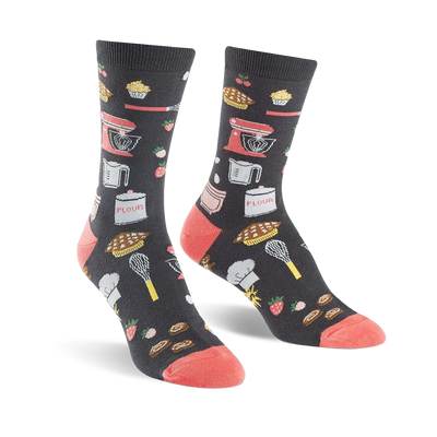Pair of crew socks in dark gray with coral toes and heels. The socks are adorned with illustrations of kitchen tools, baked goods, and strawberries.
