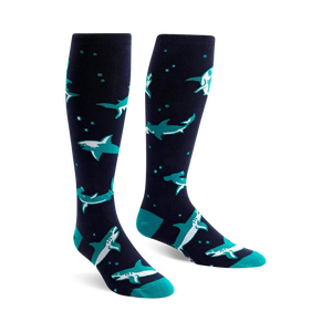 Pair of navy blue knee-high socks with teal hammerhead sharks and small white bubbles. Fun and playful design.