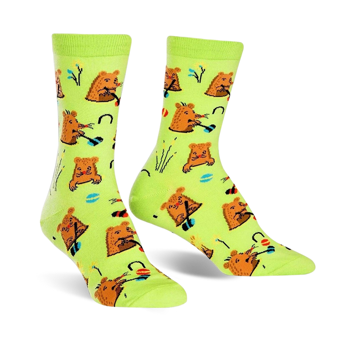 green crew socks feature a pattern of brown moles playing whack-a-mole in red, yellow, and blue hats, with flowers and grass.   }}