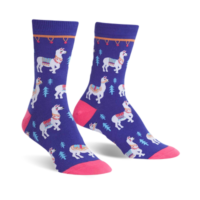 Pair of purple crew socks featuring white llamas with colorful saddles and small green trees. Pink toe and cuff detail.