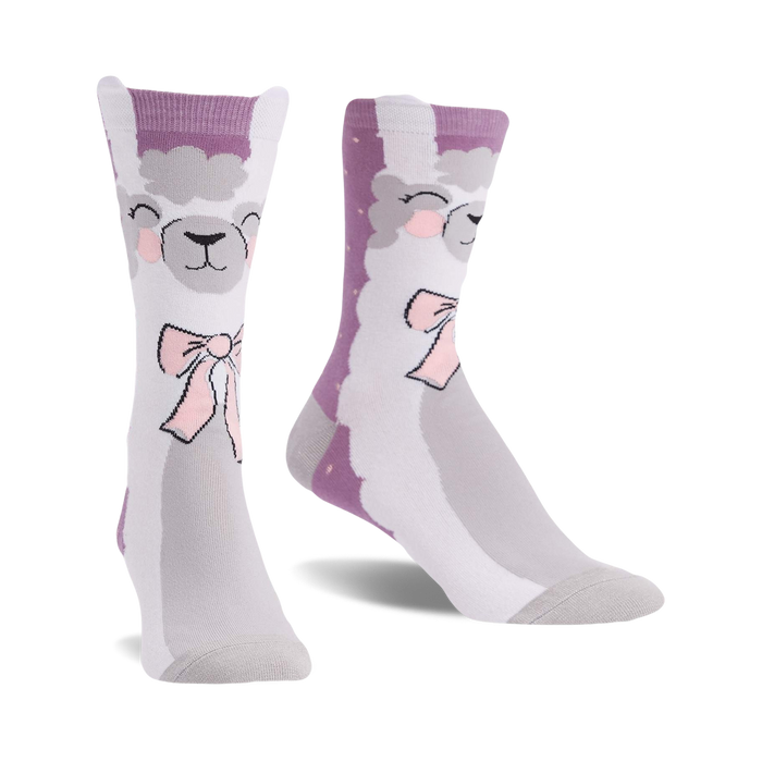 Pair of crew socks showcasing a whimsical llama design. The socks are primarily grey and light purple with a cute llama face and pink bow. }}