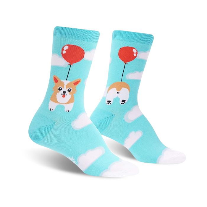 Crew socks in teal blue featuring a corgi dog attached to a red balloon, floating amongst white clouds. The other sock displays the corgi's bottom. }}