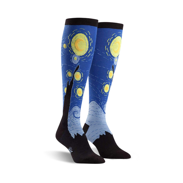 knee-high women's socks in blue with a yellow and white dot pattern and black mountain/tree shapes; art & literature theme.  