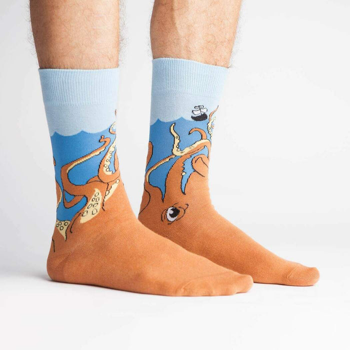A pair of blue socks with an octopus design on each sock. The octopus design is of a cartoon octopus with its tentacles wrapped around the wearer's leg.