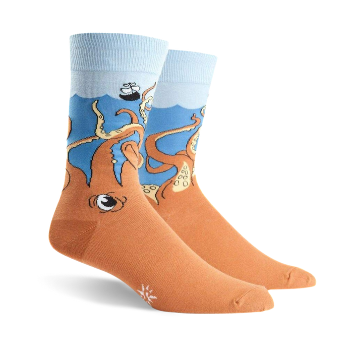 Pair of crew socks; orange body with a blue ocean top and cartoon octopus design, a sinking ship is partially visible above the octopus.