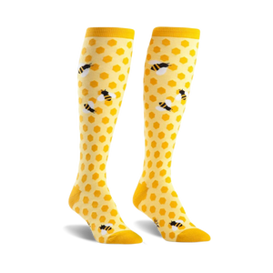 Pair of yellow knee-high socks with a honeycomb pattern and cute bee illustrations.