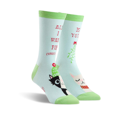 Pair of crew socks in teal green featuring a black and white cat, a llama wearing a scarf, mistletoe, and the text 'All I want for Christmas is you!'