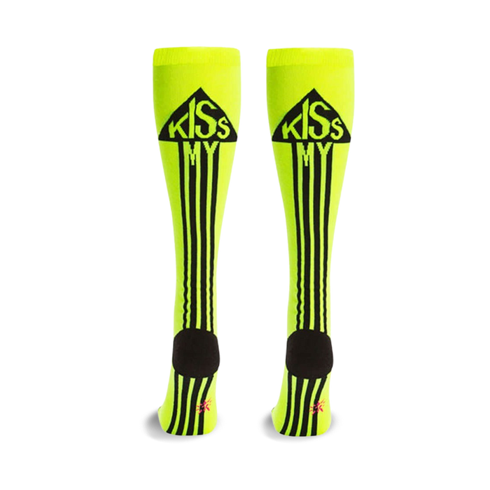 Pair of neon yellow knee-high socks with black stripes and a 'Kiss My' graphic in a black triangle at the top. Black heel and toe. }}