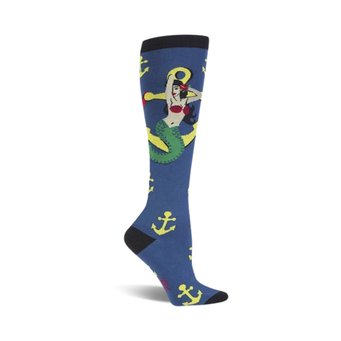 Knee-high socks in navy blue, adorned with a whimsical mermaid wrapped around a yellow anchor. Yellow anchors are scattered across the sock. }}