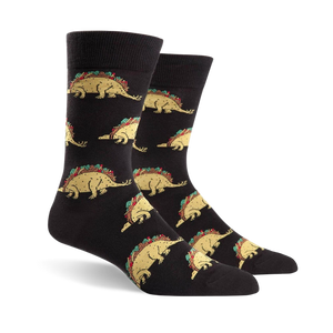 Pair of black crew socks featuring a repeating pattern of tacosaurus illustrations. The tacosaurus is a dinosaur-shaped taco with all the fixings.