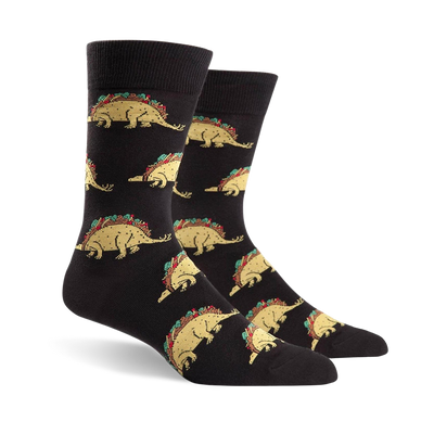 Pair of black crew socks featuring a repeating pattern of tacosaurus illustrations. The tacosaurus is a dinosaur-shaped taco with all the fixings.