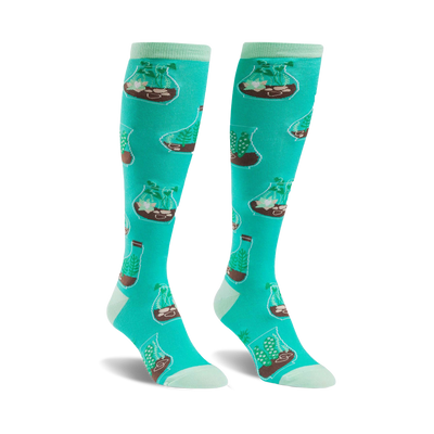 Pair of teal knee-high socks with a repeating pattern of terrariums containing various plants.