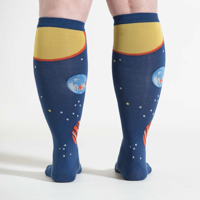 A pair of blue knee-high socks with a planet pattern.