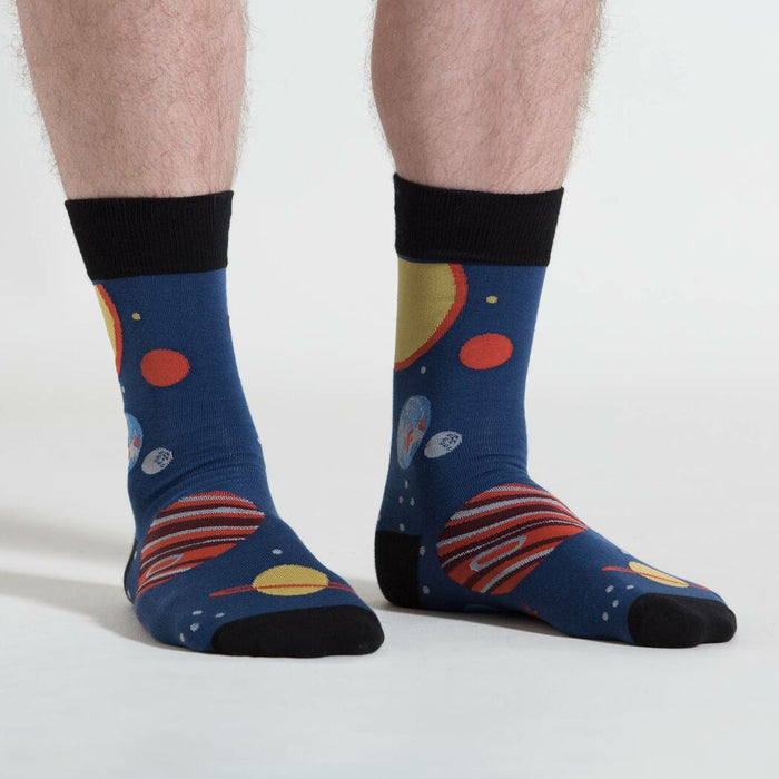 A pair of blue socks with a pattern of planets and stars.
