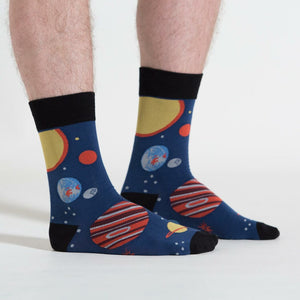 A pair of blue socks with a pattern of planets and stars.