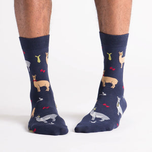 A pair of blue socks with a pattern of llamas wearing bow ties.