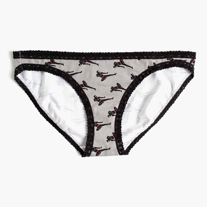 Grey hipster socks with a black lace trim. The socks feature a repeating pattern of black silhouettes of women in ninja poses with accents of red. }}