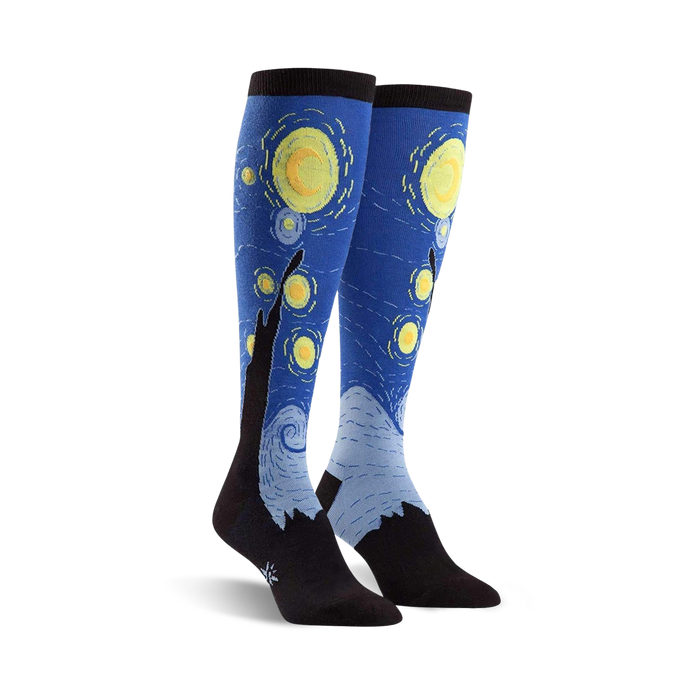 Pair of knee-high socks showcasing Van Gogh's Starry Night.  Blues, yellows, and blacks are prominent in the design, with swirling brushstrokes and stars.