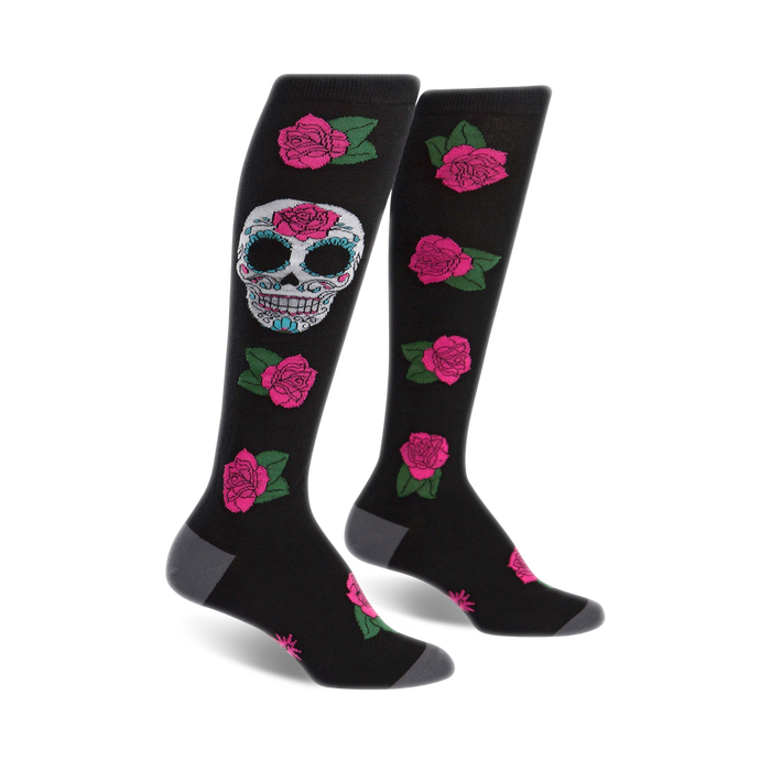 Pair of black knee-high socks with a colorful sugar skull and pink roses pattern. }}