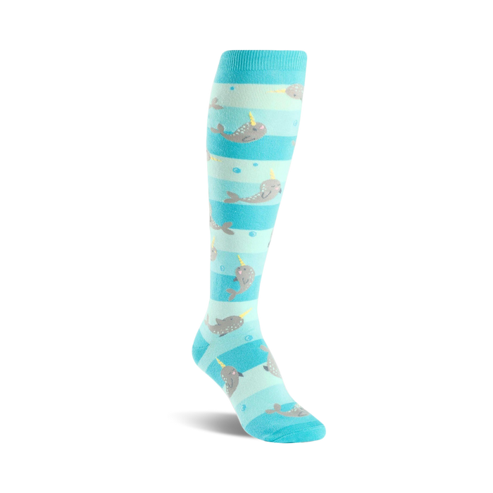 Knee-high socks in teal and light blue with a playful narwhal pattern. The narwhals are grey with yellow horns, swimming amongst light blue bubbles. }}