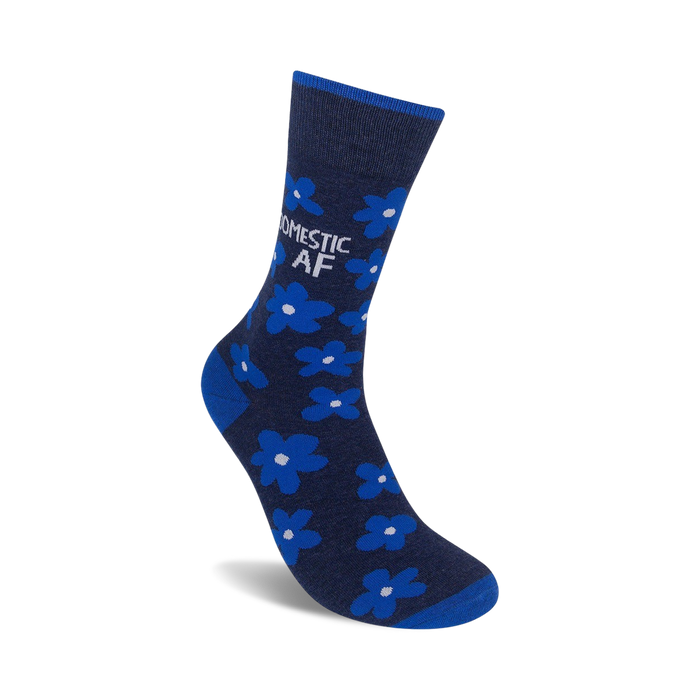 A pair of mid-calf socks with a dark blue background and a pattern of small white flowers. The socks have the words 