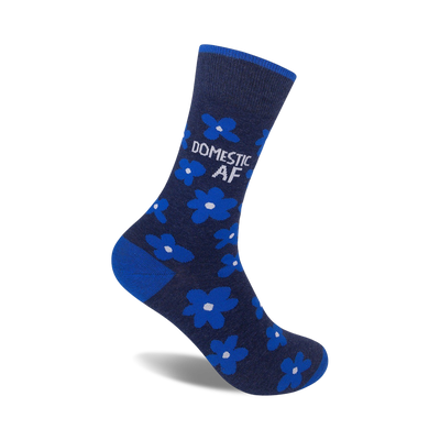 A single navy blue crew sock with bright blue flowers and the text 'DOMESTIC AF' in white.