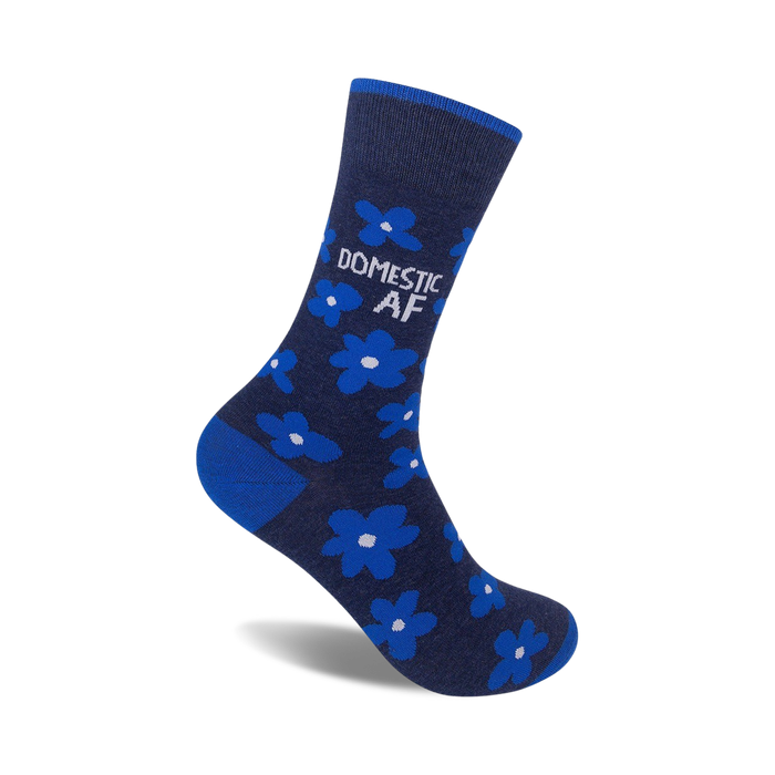 A single navy blue crew sock with bright blue flowers and the text 'DOMESTIC AF' in white.