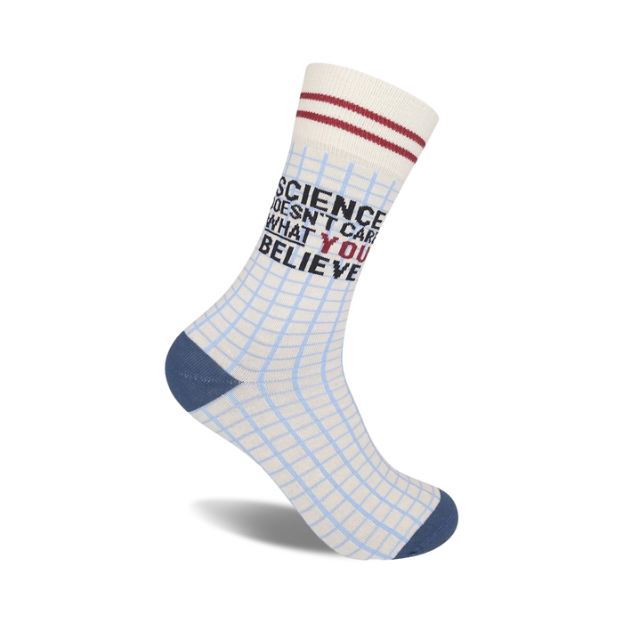 Crew socks in off-white with a light blue grid pattern.  Red and black text reads 'Science Doesn't Care What You Believe'.  Navy blue heel and toe. }}