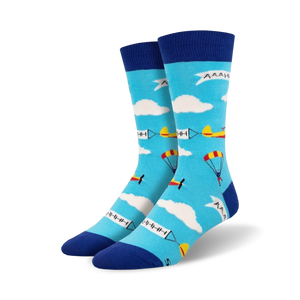 mens skydiver crew socks with light blue background, white clouds, four skydivers with colored parachutes, and two airplanes.  
